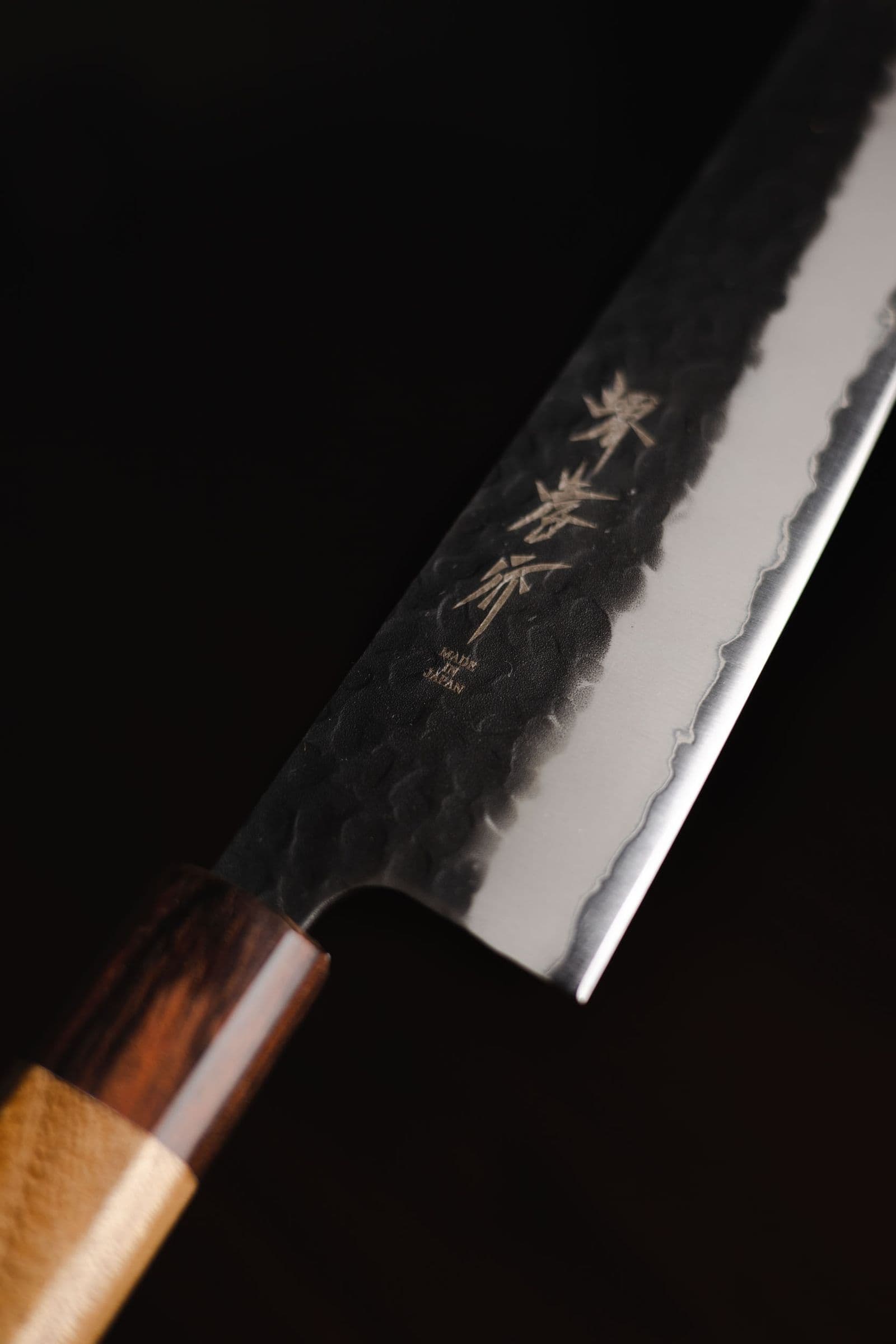 Hand-forged Japanese gyuto knife with a hammered kurouchi finish and an octagonal wooden handle